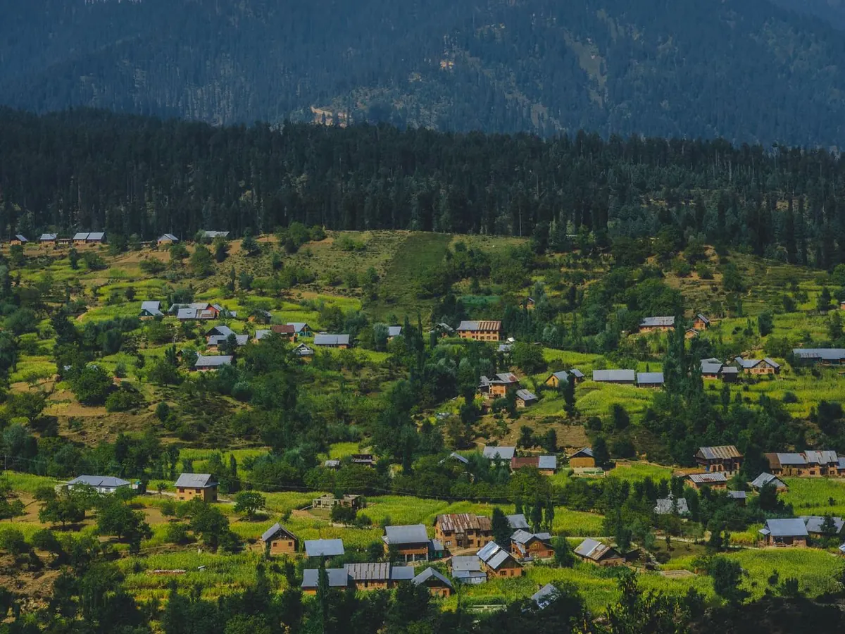 Village on a hillside above a green valley in Kashmir